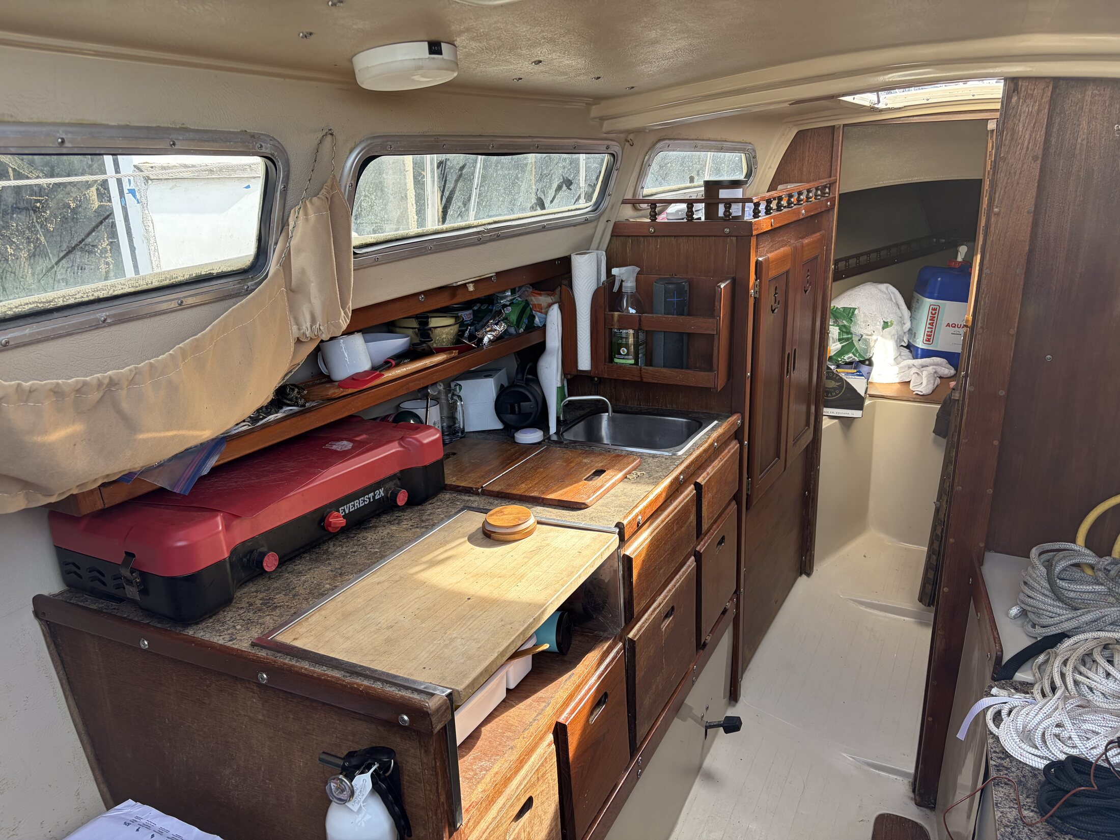 Cabin interior with galley, sink, and wood cabinetry
