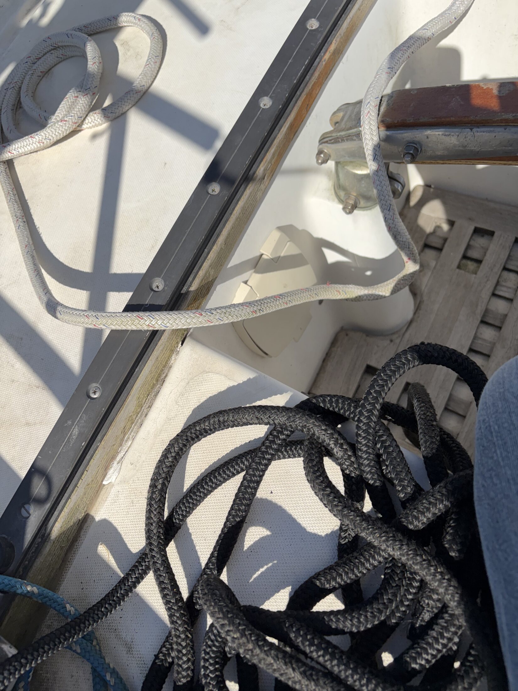 Mainsheet traveler track and control lines in cockpit
