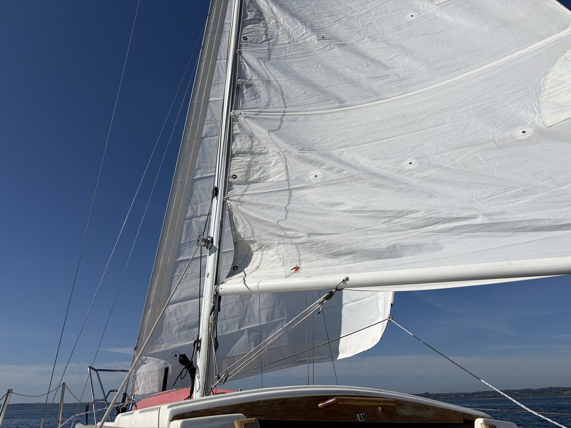 Genoa and mainsail raised on open water